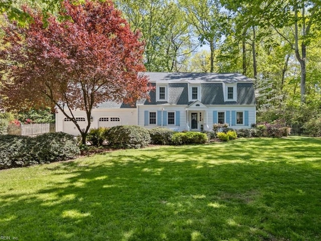 dutch colonial featuring a gambrel roof, a shingled roof, and an attached garage