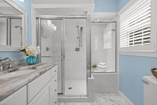 full bathroom featuring a shower stall, vanity, and toilet