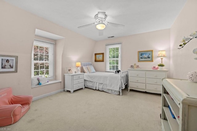 bedroom featuring light colored carpet, ceiling fan, and baseboards