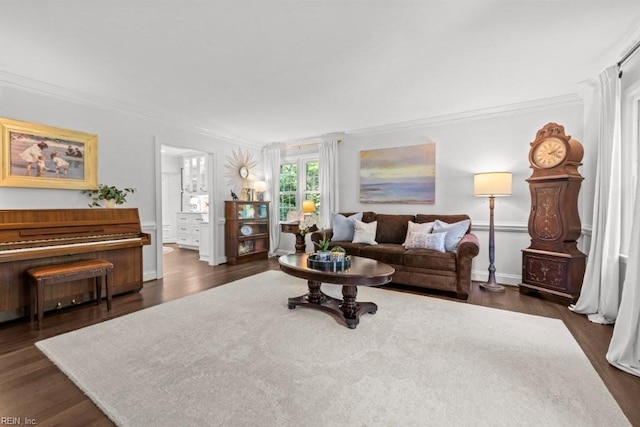 living area with crown molding, dark wood finished floors, and baseboards