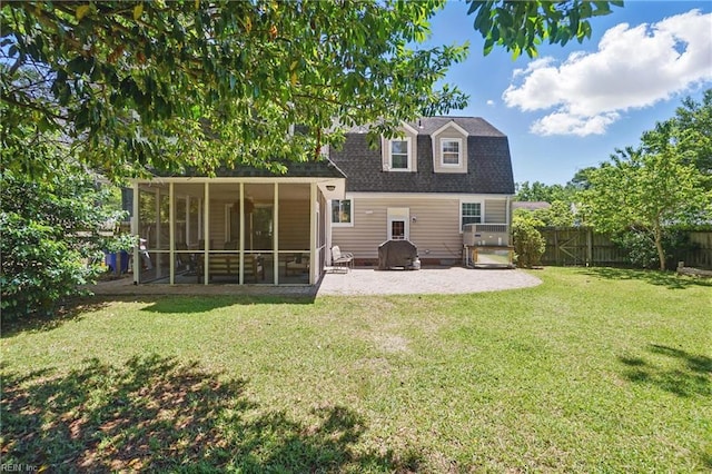 back of house featuring a sunroom, a patio, roof with shingles, and a gambrel roof