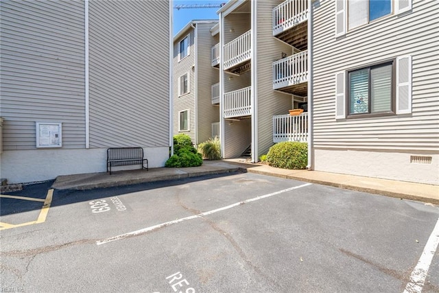 view of apartment building / complex featuring uncovered parking