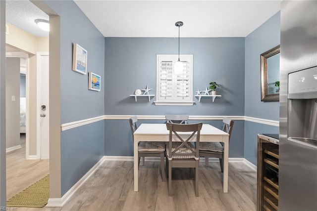 dining area featuring wood finished floors and baseboards