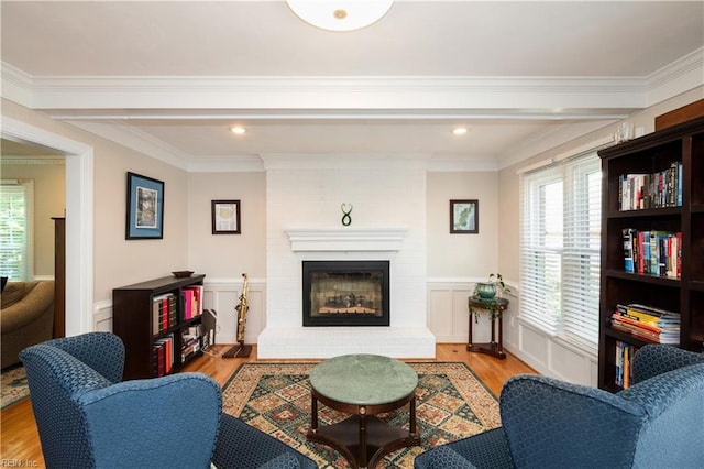 338 W Olney Rd, Norfolk, VA 23507 - living area featuring wood finished floors, wainscoting, a brick fireplace, and ornamental molding