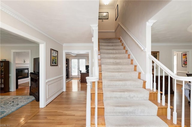 338 W Olney Rd, Norfolk, VA 23507 - stairway with wood finished floors, crown molding, and a glass covered fireplace