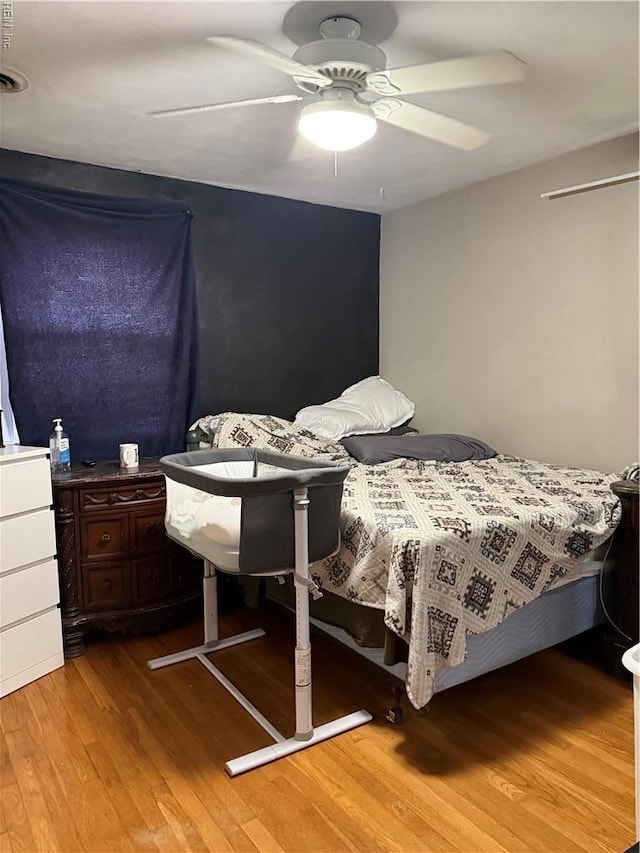 bedroom with light wood-type flooring and a ceiling fan