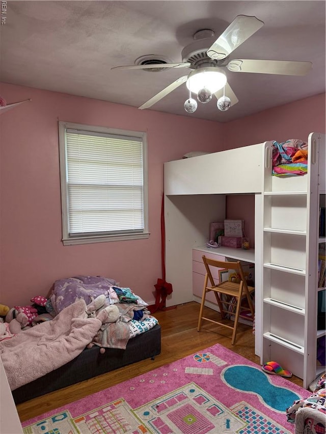 bedroom featuring wood finished floors and ceiling fan