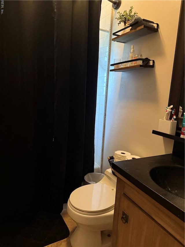 full bath with vanity, toilet, a shower, and tile patterned flooring