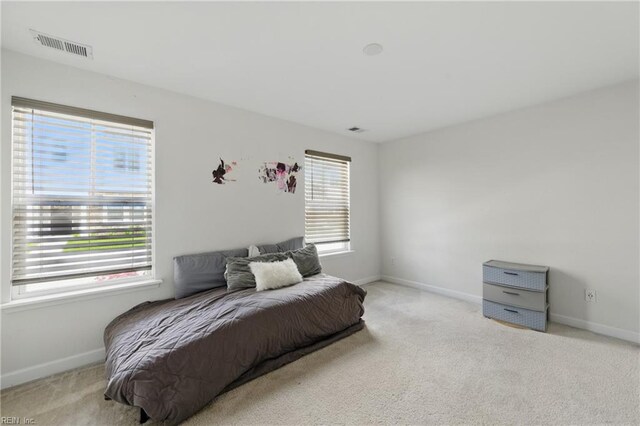 carpeted bedroom featuring baseboards