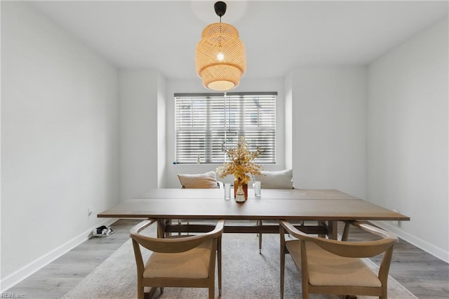 dining room featuring baseboards and wood finished floors