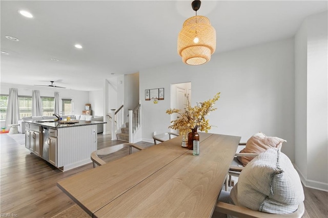 dining space with stairs, dark wood finished floors, recessed lighting, baseboards, and a ceiling fan