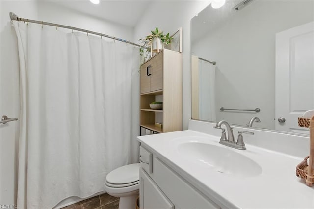 bathroom featuring toilet, vanity, tile patterned floors, and a shower with shower curtain