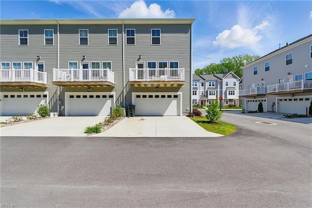 view of front of house with a garage, driveway, and a residential view