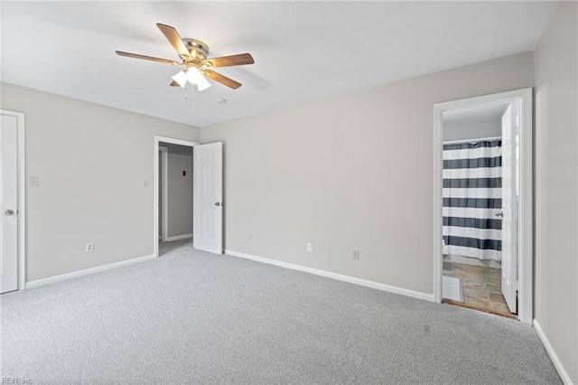 unfurnished bedroom featuring carpet, baseboards, and connected bathroom