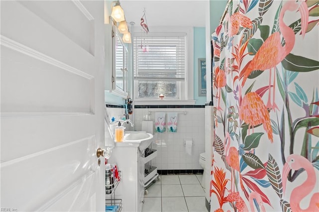 bathroom featuring tile walls, tile patterned flooring, toilet, vanity, and a shower with curtain