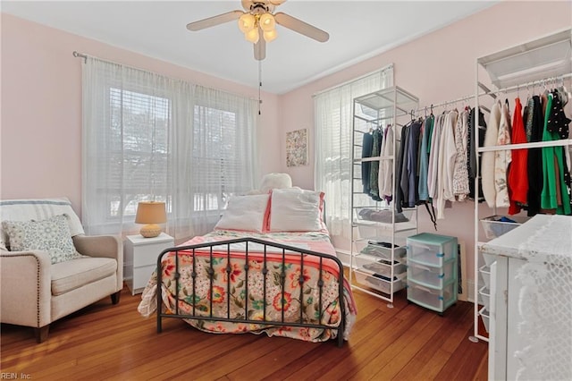 bedroom with hardwood / wood-style floors and ceiling fan