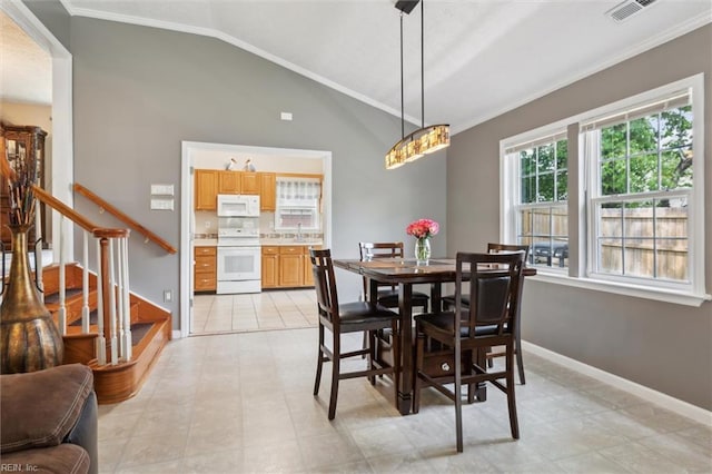 dining space featuring ornamental molding, stairs, vaulted ceiling, and baseboards