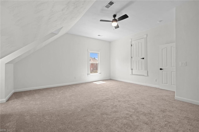 bonus room featuring carpet, vaulted ceiling, baseboards, and a ceiling fan