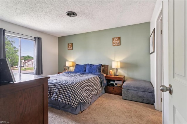 bedroom with carpet flooring, a textured ceiling, and access to exterior