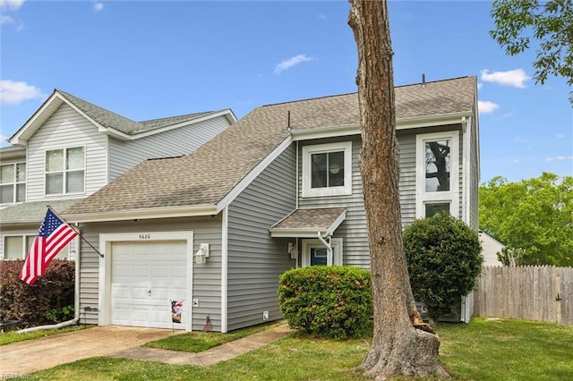 view of front of home featuring a garage, driveway, and roof with shingles