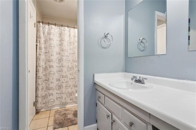 bathroom with vanity, toilet, and tile patterned floors