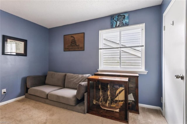 living area featuring carpet floors and baseboards