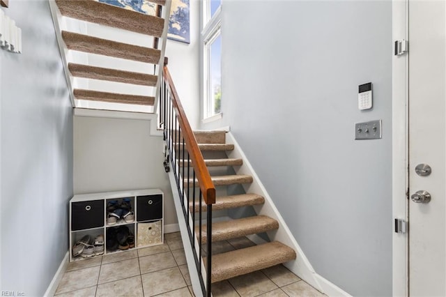 staircase with tile patterned flooring and baseboards