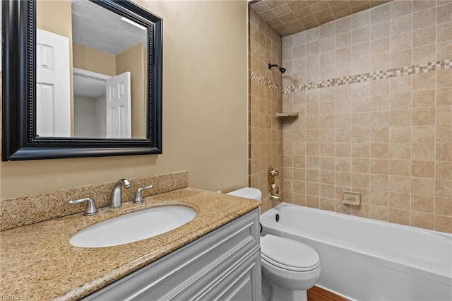 bathroom with shower / bath combination, toilet, and vanity