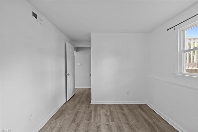 empty room with wood finished floors and baseboards