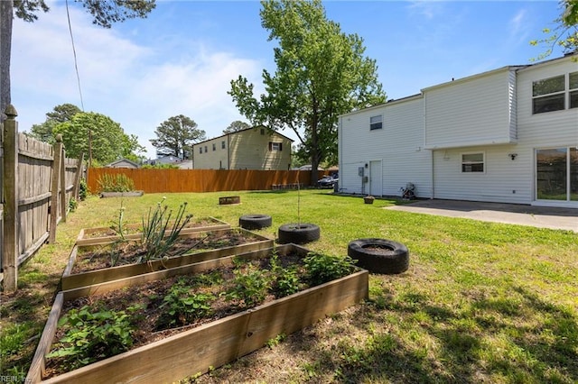 view of yard with a vegetable garden and a patio area