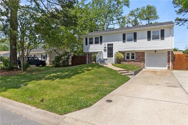 bi-level home featuring brick siding, concrete driveway, and a garage