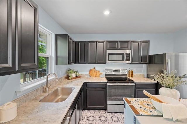 703 Lakeview Cv, Smithfield, VA 23430 - kitchen featuring appliances with stainless steel finishes, a sink, light stone countertops, and recessed lighting