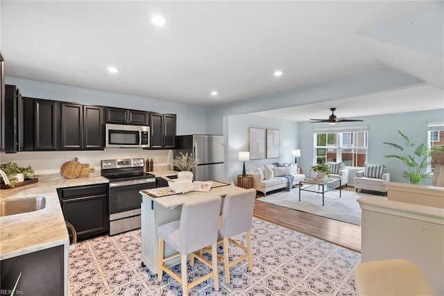 703 Lakeview Cv, Smithfield, VA 23430 - kitchen featuring stainless steel appliances, a sink, recessed lighting, a ceiling fan, and light wood finished floors