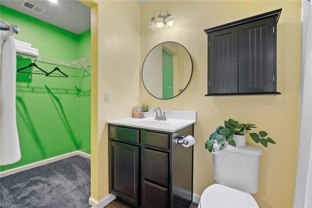 703 Lakeview Cv, Smithfield, VA 23430 - bathroom featuring toilet, baseboards, and vanity