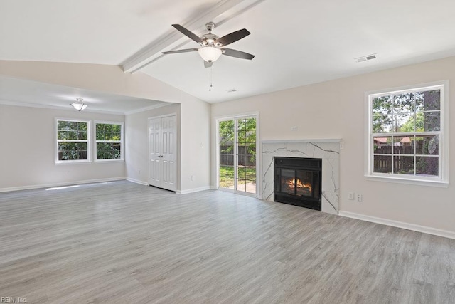unfurnished living room with wood finished floors, a fireplace, baseboards, and a ceiling fan