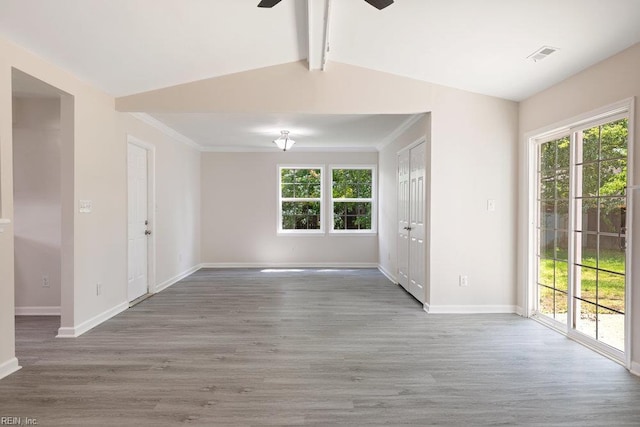unfurnished room featuring ceiling fan, wood finished floors, baseboards, and crown molding