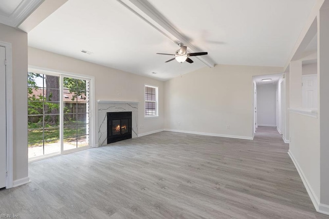 unfurnished living room with light wood finished floors, ceiling fan, and baseboards