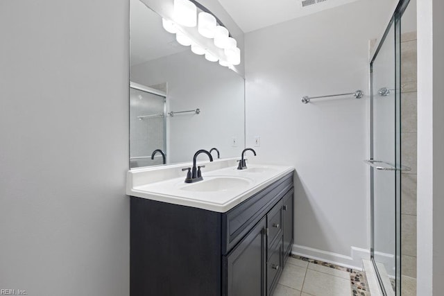 bathroom featuring a shower stall, tile patterned floors, and double vanity