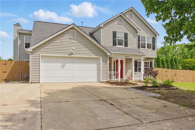 traditional home with a gate, concrete driveway, an attached garage, covered porch, and roof with shingles