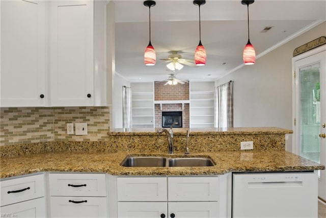 kitchen with white dishwasher, a sink, a ceiling fan, white cabinetry, and light stone counters