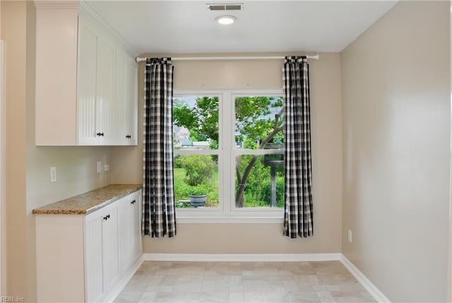 unfurnished dining area with baseboards