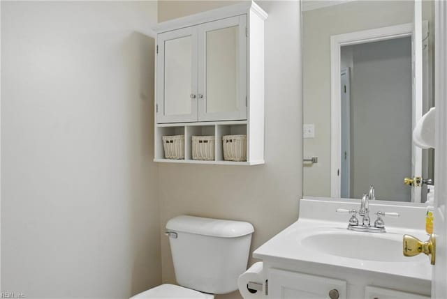 half bath featuring toilet and vanity