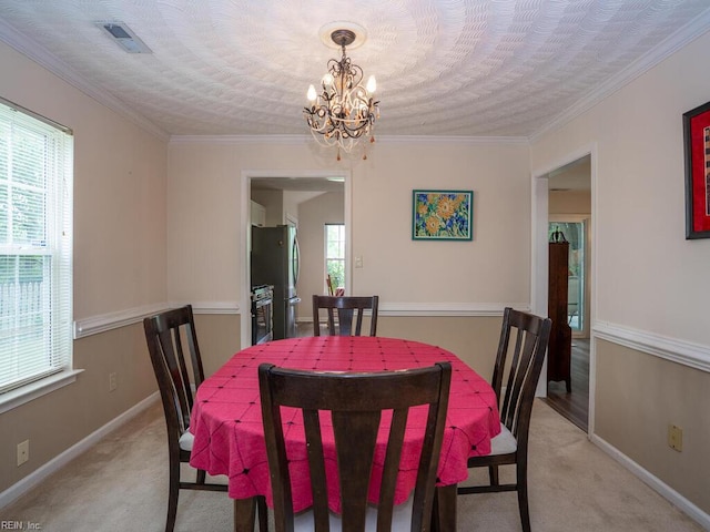 dining area featuring light colored carpet, a chandelier, baseboards, and ornamental molding