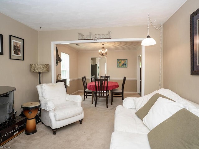 living area with light colored carpet and a chandelier