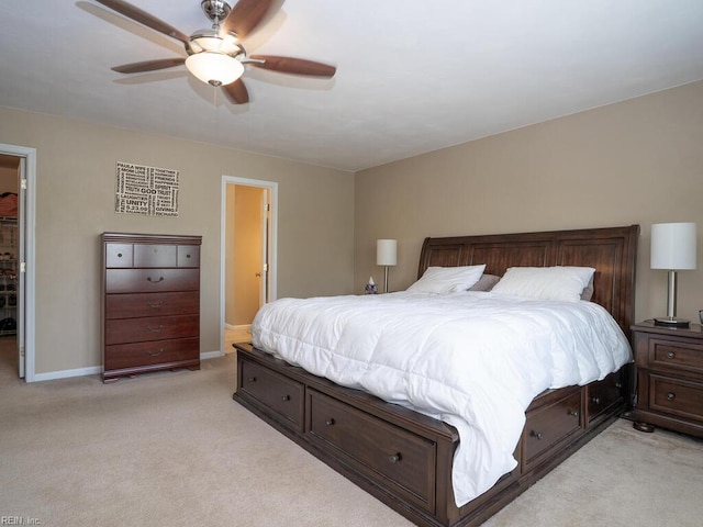 bedroom featuring light carpet, baseboards, and a ceiling fan