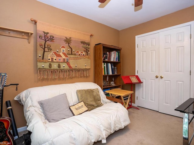 sitting room with ceiling fan and carpet floors