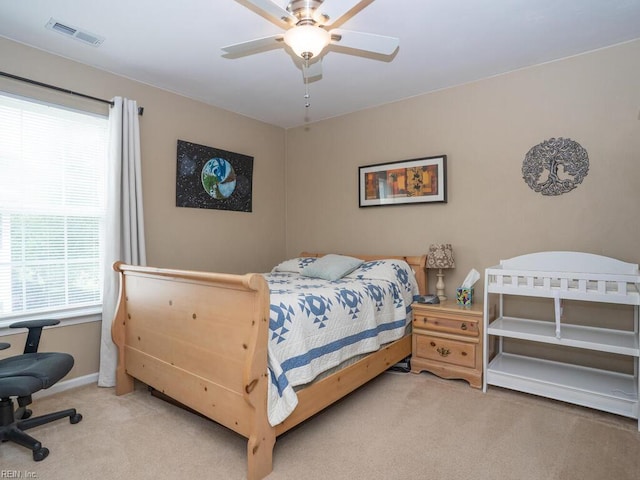 bedroom featuring light carpet, baseboards, and a ceiling fan