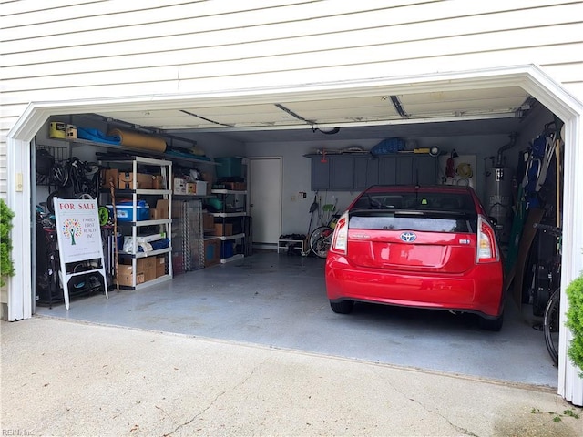 garage featuring water heater and driveway