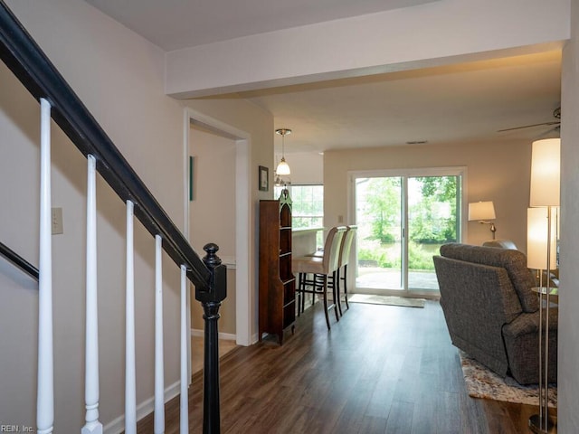living area with dark wood finished floors and stairs
