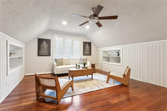 1276 Hebden Cv, Virginia Beach, VA 23452 - living area featuring built in shelves, a textured ceiling, wood finished floors, baseboards, and a ceiling fan